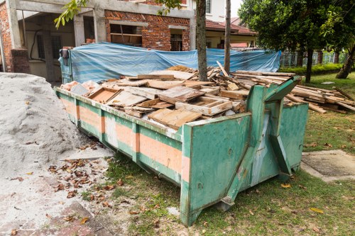 Professionals removing a sofa from a living room in North West London